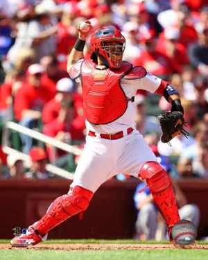 A Baseball Player In Red Gear Is Ready To Catch A Ball Wallpaper
