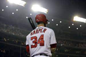 A Baseball Player Is Holding A Bat Wallpaper