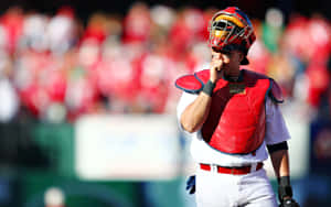 A Baseball Player Is Holding His Glove And Looking At The Ground Wallpaper