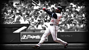 A Baseball Player Swinging A Bat Wallpaper