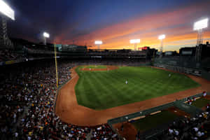 A Baseball Stadium At Sunset Wallpaper