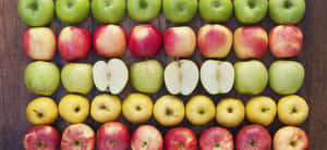 A Basket Brimming With Fresh Fall Apples Wallpaper