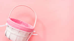 A Basket With A Pink Bow On A Pink Background Wallpaper