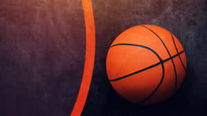 A Basketball In A Court At Dusk Wallpaper