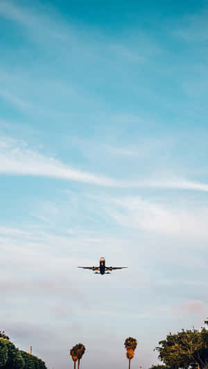 A Beautiful Aerial Shot Of A Plane Soaring Through The Sky Wallpaper