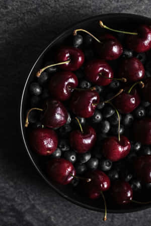 A Beautiful And Fragrant Black Cherry On A Sunny Day Wallpaper