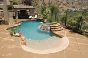A Beautiful Beach Swimming Pool Overlooking The Ocean Wallpaper