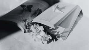 A Beautiful Black And White Book On A Wooden Surface Wallpaper