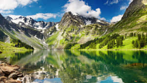 A Beautiful Mountain Lake With Forest In The Background Wallpaper