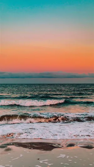 A Beautiful Sand Beach With An Iphone Taking In The View Wallpaper