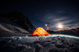 A Beautiful Snowy Campsite At The Heart Of A Serene Winter Forest Wallpaper