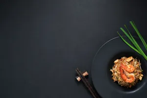 A Beautiful Sunrise Over The Horizon, Framed By A Meadow Of Greenery. Wallpaper