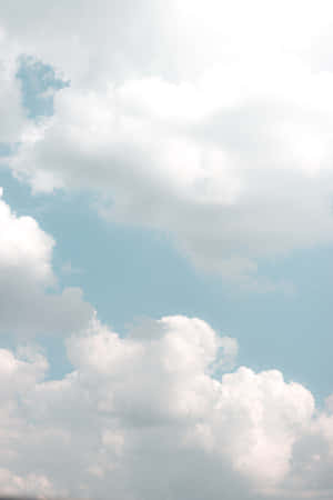 “a Beautiful View Of Tranquil White Clouds In The Bright Blue Sky” Wallpaper