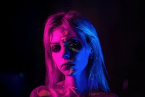 A Beautiful Woman Dressed In Purple Against A Dreamy Purple Background Wallpaper