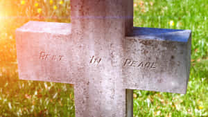 A Beautifully Haunting Gravestone At Sunset Wallpaper