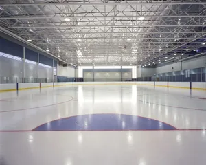 A Beautifully Lit Ice Rink At Night With Skaters Enjoying The Experience Wallpaper