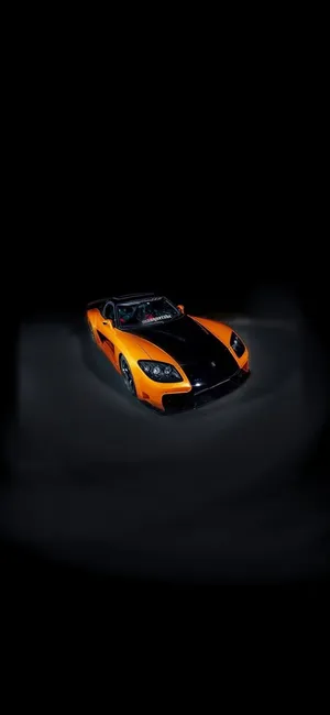 A Black And Orange Sports Car In The Dark Wallpaper