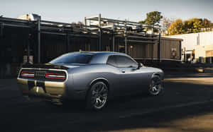 A Black And Silver Car Parked In Front Of A Building Wallpaper