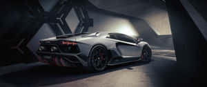 A Black And Silver Sports Car Is Parked In A Dark Tunnel Wallpaper