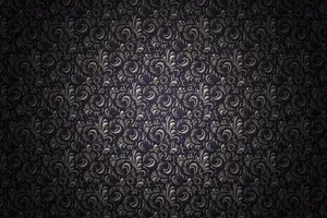 A Black And Silver Wallpaper With Swirls Wallpaper