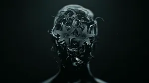 A Black And White Image Of A Woman's Head With Flowers Wallpaper