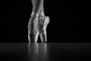 A Black And White Photo Of A Ballet Dancer Wallpaper