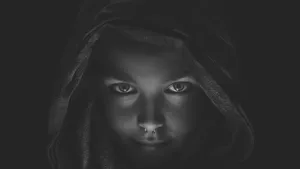 A Black And White Photo Of A Girl With A Hood Wallpaper