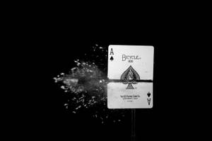 A Black And White Photo Of A Playing Card With A Splash Of Water Wallpaper