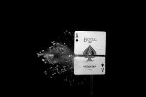 A Black And White Photo Of A Playing Card With A Splash Of Water Wallpaper