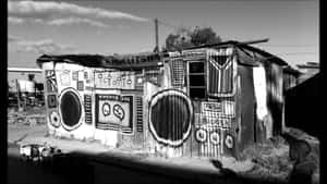 A Black And White Photo Of A Shack With Speakers Wallpaper