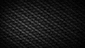 A Black Background With A Pattern Of Holes Wallpaper