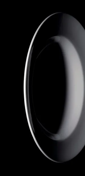 A Black Plate With A Circular Shape On A Black Background Wallpaper