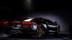 A Black Sports Car Is Parked In A Dark Room Wallpaper