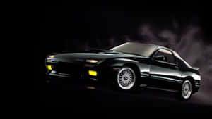 A Black Sports Car Is Shown In A Dark Background Wallpaper