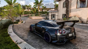 A Black Sports Car Parked On A Driveway Wallpaper