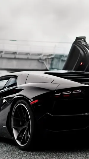 A Black Sports Car With Its Doors Open Wallpaper