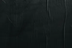 A Black Wall With A Black Paint Wallpaper