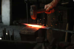 A Blacksmith Laboring At The Forge Wallpaper