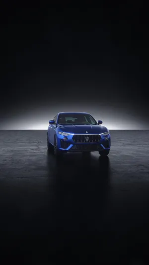 A Blue Car Poised For Its Next Adventure Wallpaper