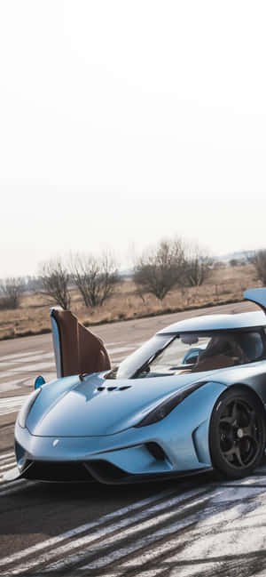 A Blue Sports Car Is Driving On The Road Wallpaper