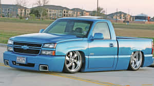 A Blue Truck Parked On The Street Wallpaper