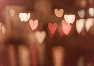 A Blurred Image Of Hearts On A Dark Background Wallpaper