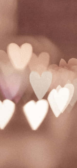 A Blurry Image Of Hearts In A Blurry Background Wallpaper