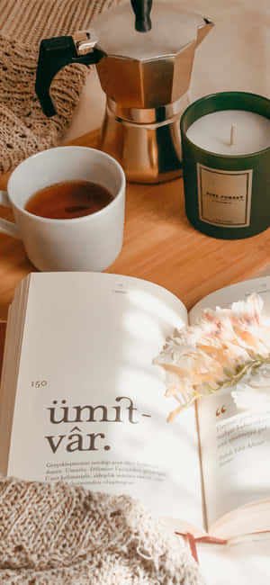 A Book, Tea, And Candle On A Bed Wallpaper