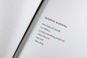 A Book With The Words Internal Bleeding Wallpaper