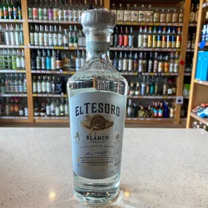 A Bottle Of El Tesoro Blanco Tequila Showcased In A Liquor Shop Wallpaper