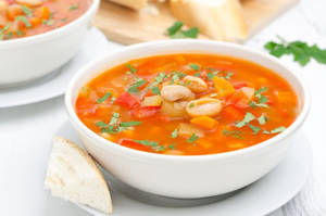 A Bowl Of Nutritious Vegetable Soup With White Beans Wallpaper