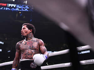 A Boxer With Tattoos Standing In The Ring Wallpaper