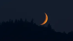 A Breathtaking Moonset Over The Mountains Wallpaper
