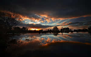 A Breathtaking Sunset Reflection Over The Lake Wallpaper